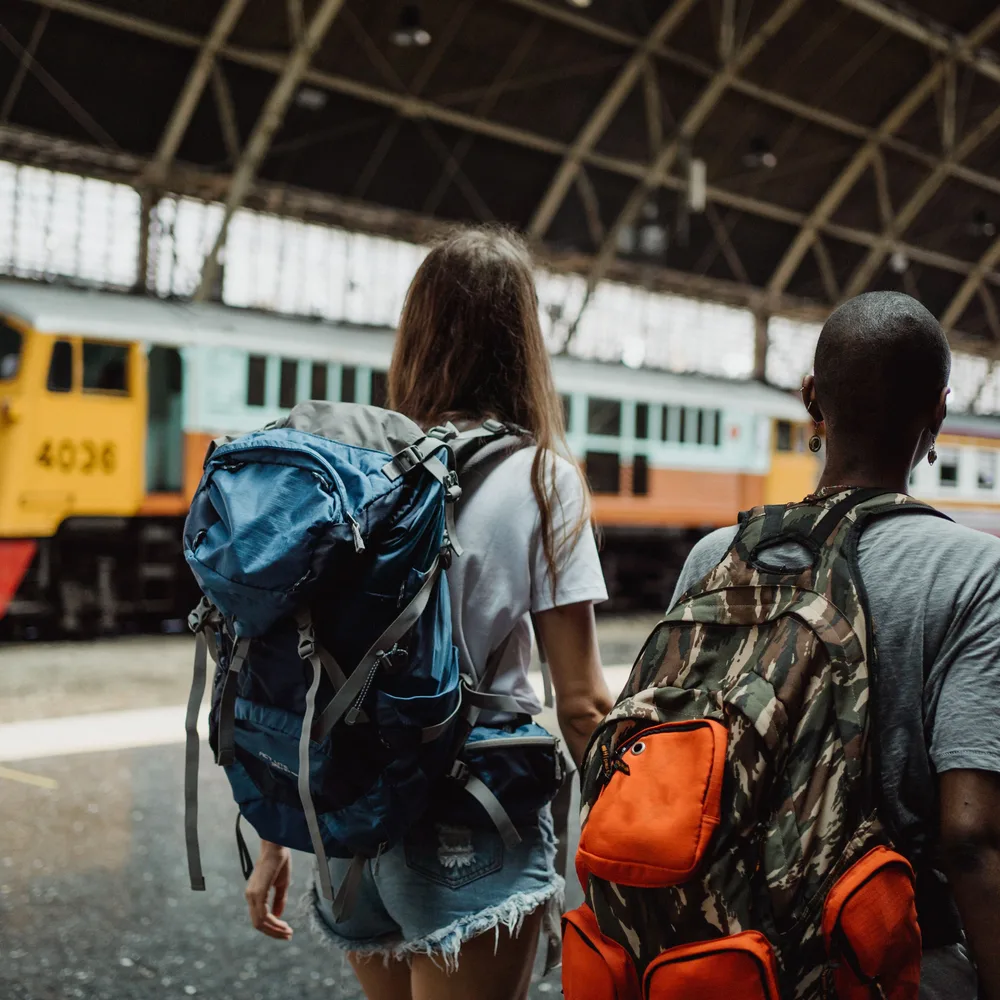 Two travelers walking toward their train