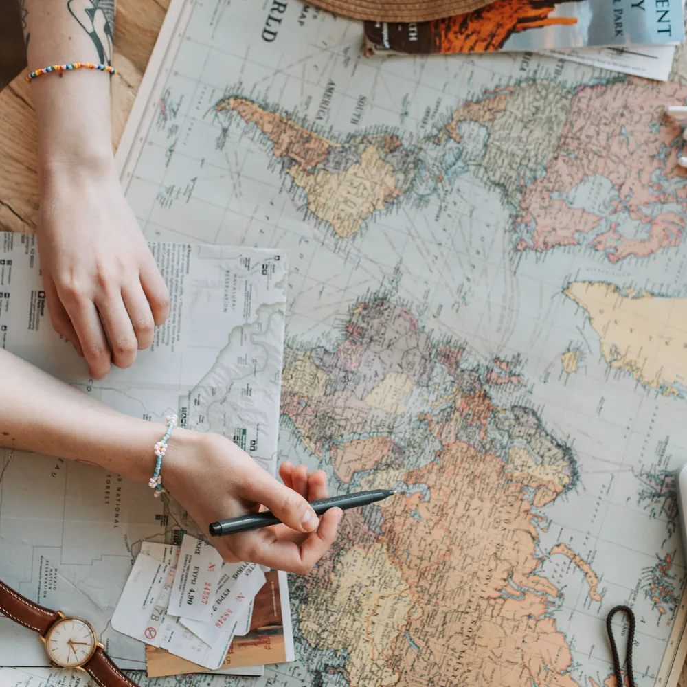 Travel essentials: map, hat, camera, watch